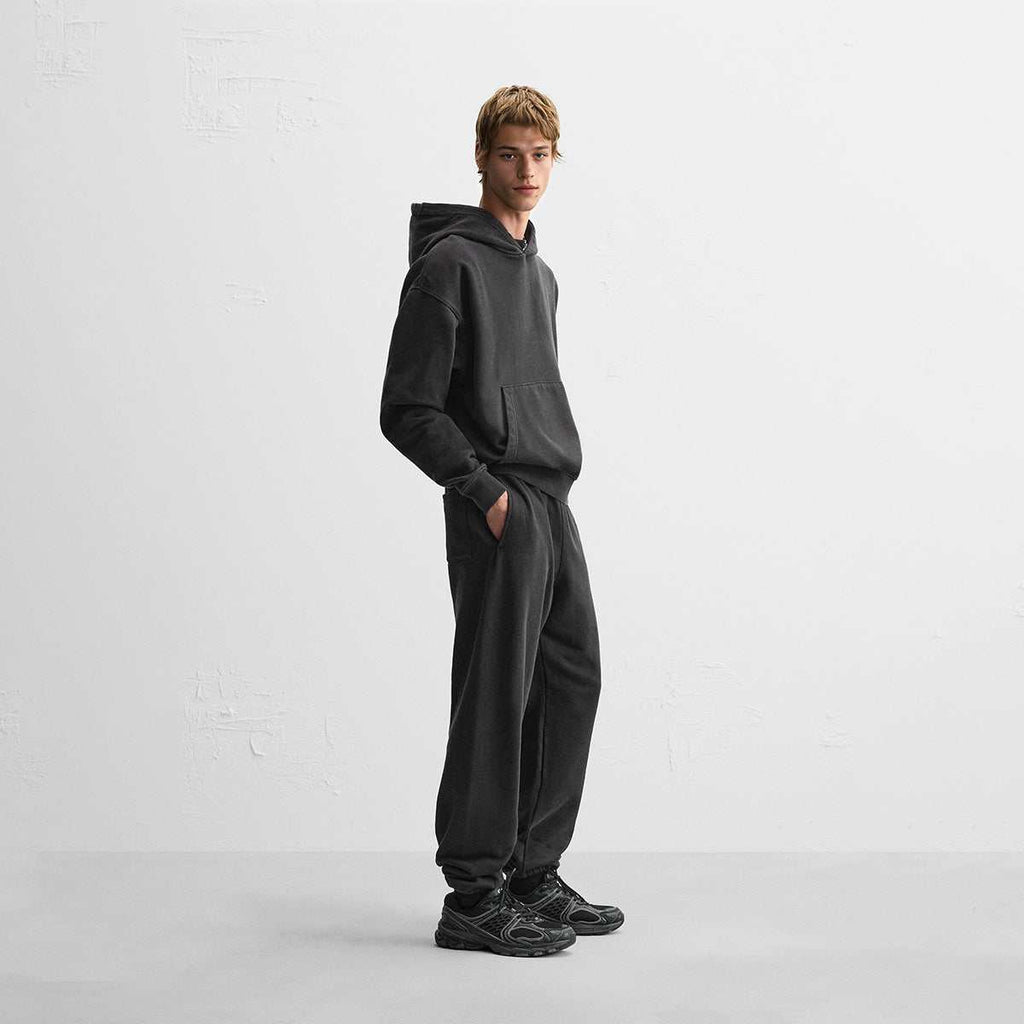440GSM Unisex Heavyweight hoodie in washed charcoal cotton fleece with a boxy fit, worn with matching relaxed sweatpants