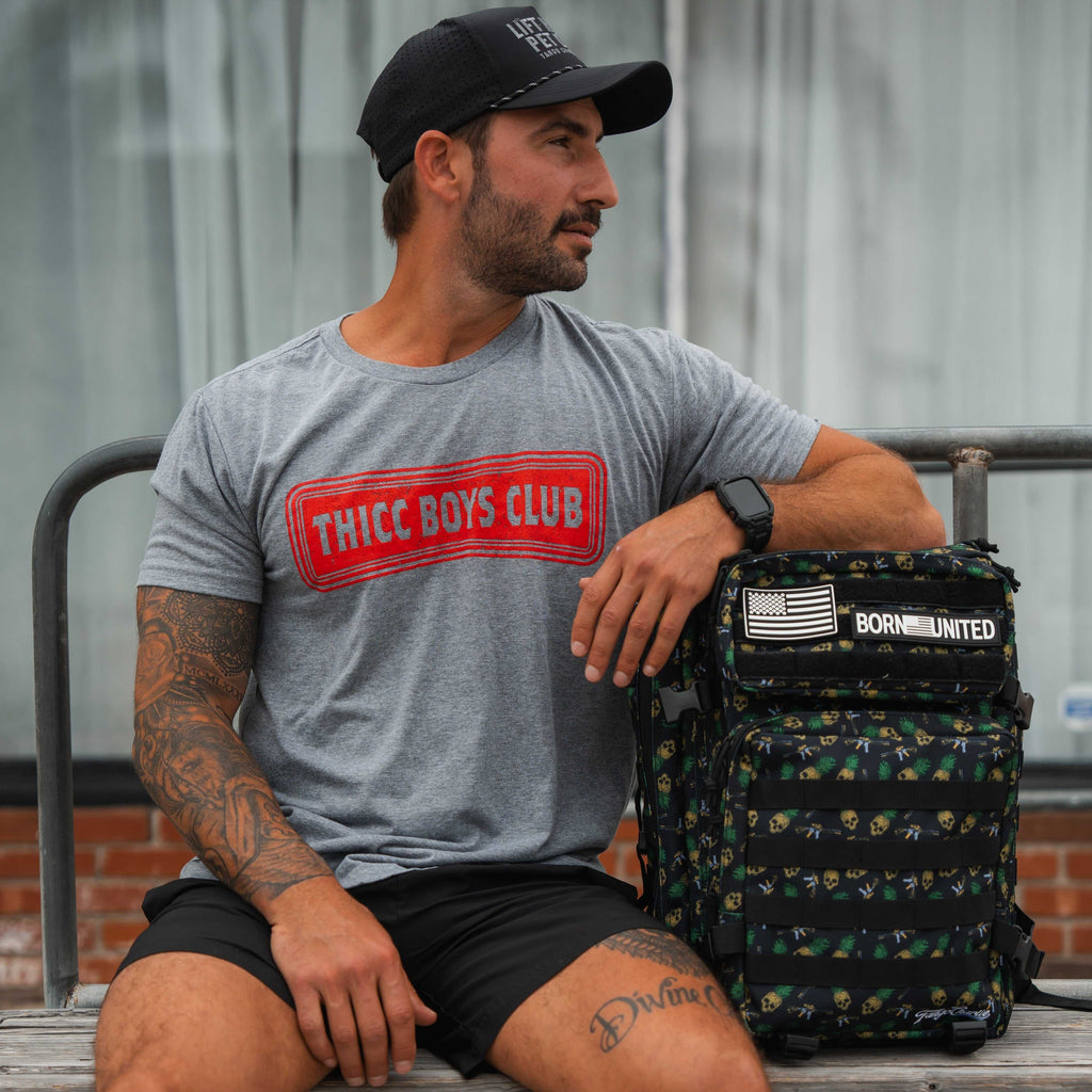 Men's THICC Boys Club tee in heather gray cotton blend, featuring a bold red outlined chest logo and crew neck.