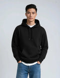 Black heavyweight pullover hoodie, Heavyweight Hoodie P2016, with soft fleece fabric, drawstring hood, and front kangaroo pocket.